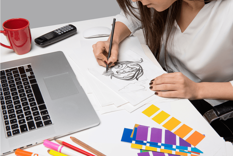 Woman drawing at a desk
